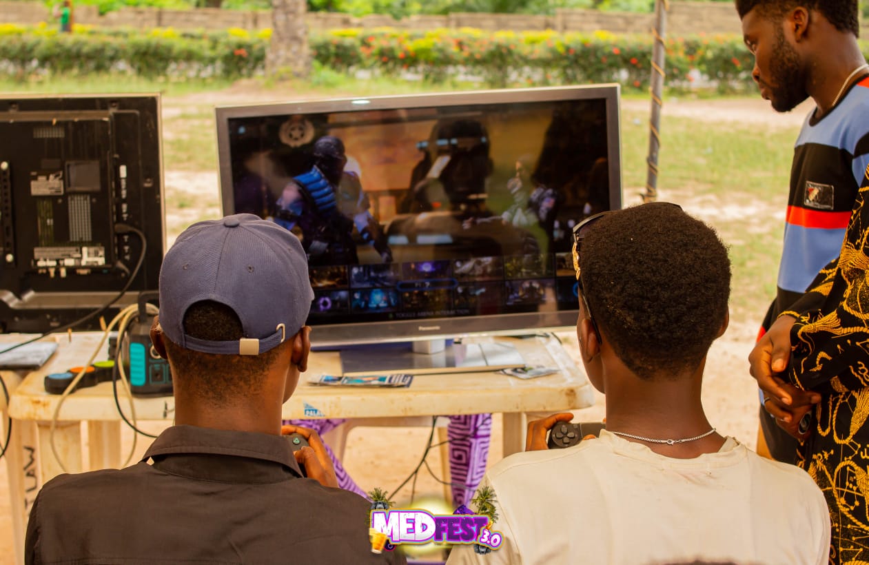 Guests gathered around a gaming screen